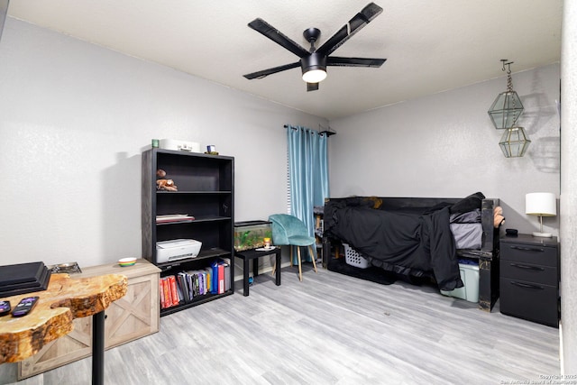 bedroom with a ceiling fan and light wood-type flooring