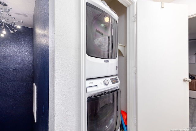 laundry area with laundry area and stacked washer / drying machine