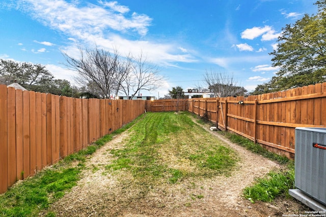 view of yard featuring central AC and a fenced backyard