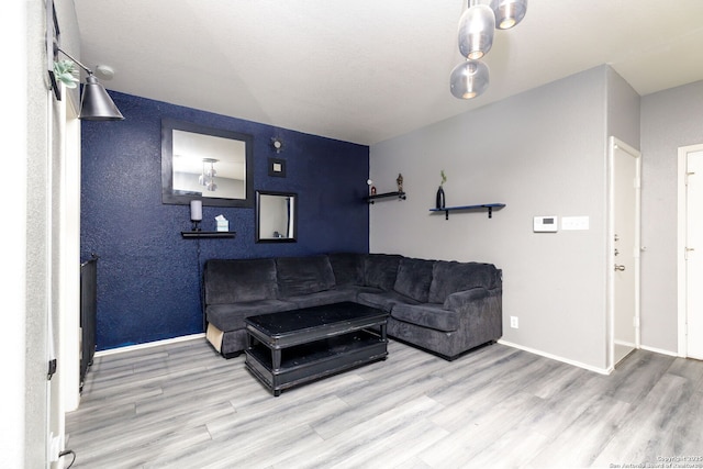 living area with wood finished floors and baseboards