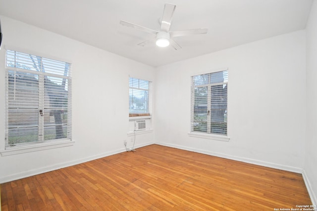 spare room with ceiling fan, baseboards, and wood finished floors