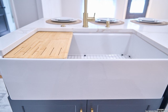 interior details with light countertops and blue cabinets