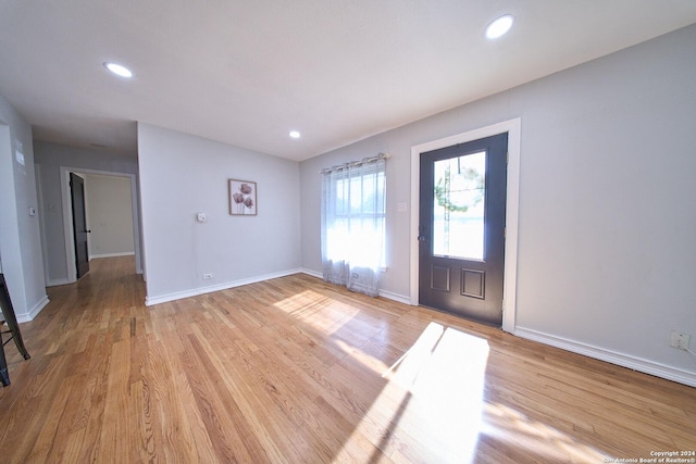 foyer entrance with light wood finished floors, baseboards, and recessed lighting