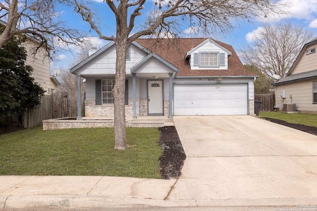 view of front of home with brick siding, a front yard, central AC, fence, and driveway