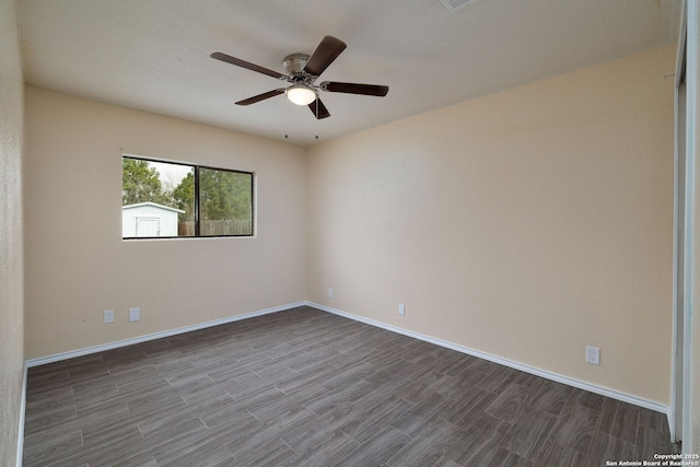 spare room with ceiling fan, baseboards, and wood finished floors