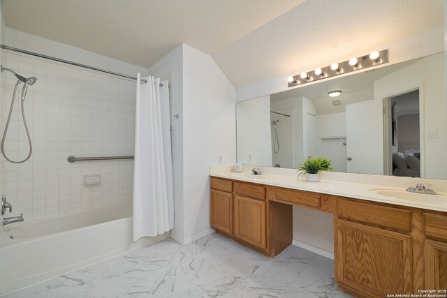 full bath featuring double vanity, marble finish floor, shower / bath combo with shower curtain, and a sink