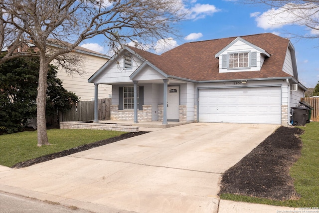 view of front of home with a garage, concrete driveway, roof with shingles, fence, and a front yard