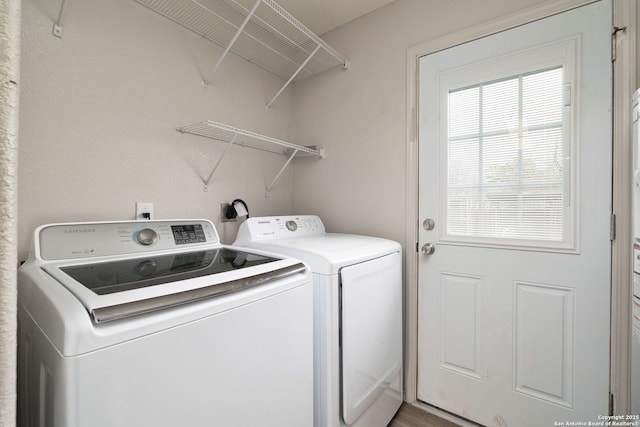 washroom featuring laundry area and washing machine and dryer