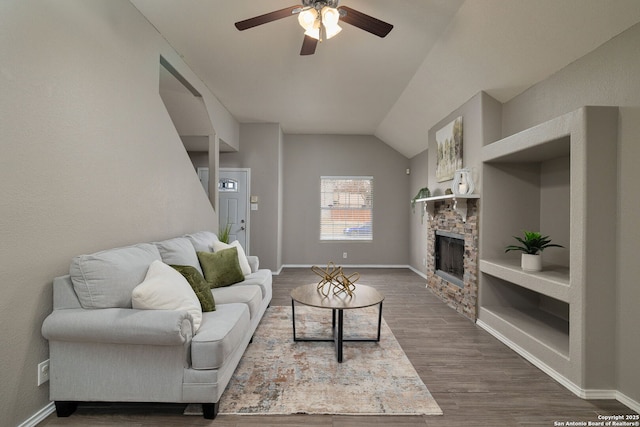 living area featuring lofted ceiling, dark wood-style flooring, a fireplace, and baseboards