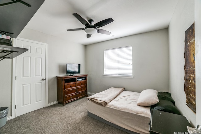 bedroom featuring light carpet, baseboards, and a ceiling fan