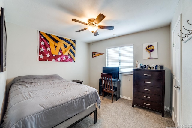 bedroom featuring ceiling fan, baseboards, and light colored carpet