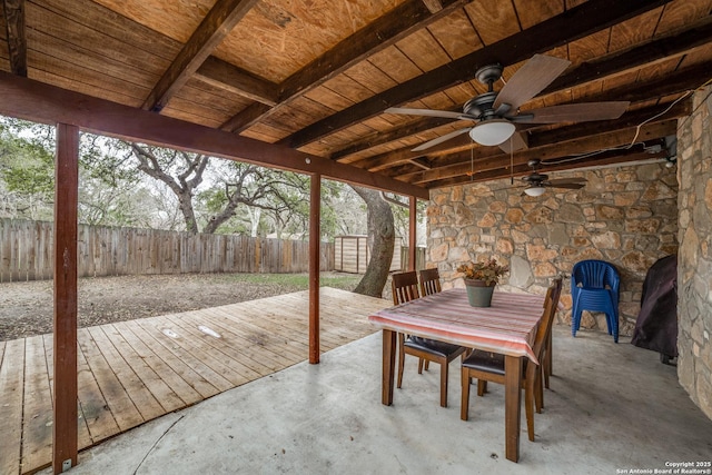 view of patio featuring a fenced backyard, a deck, a ceiling fan, and outdoor dining space