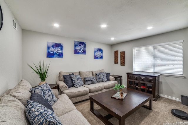 living room with light carpet, visible vents, baseboards, and recessed lighting