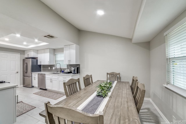 dining area with light tile patterned floors, recessed lighting, visible vents, baseboards, and a tray ceiling