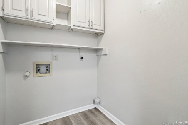 clothes washing area with hookup for a washing machine, hookup for an electric dryer, baseboards, light wood-type flooring, and cabinet space