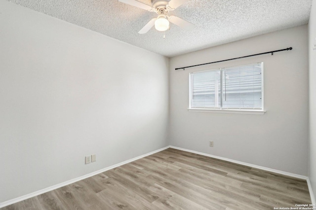 unfurnished room featuring a textured ceiling, baseboards, a ceiling fan, and light wood-style floors