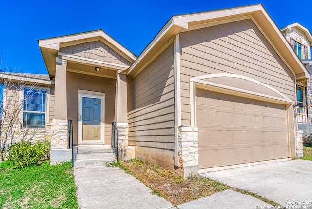 view of front of home with an attached garage and stone siding