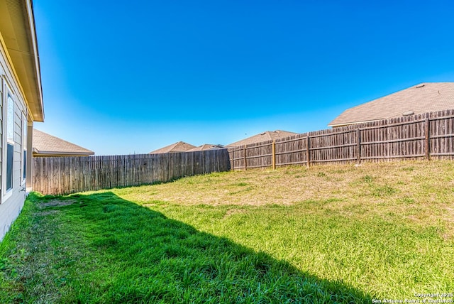 view of yard with a fenced backyard