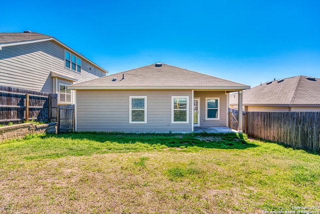 back of property with a patio, a lawn, and a fenced backyard