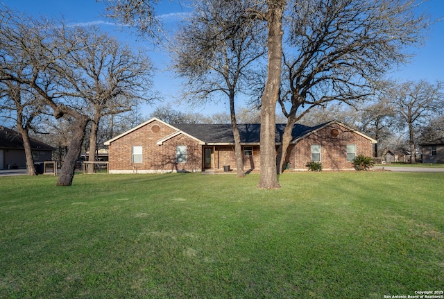 view of front of home with brick siding and a front lawn