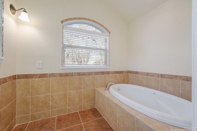 bathroom featuring lofted ceiling, a bath, and tile patterned floors