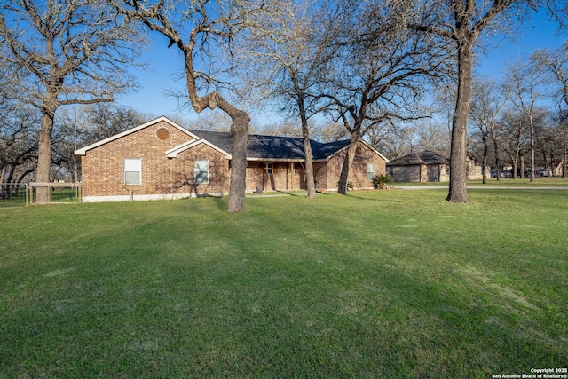 view of front facade featuring a front lawn and brick siding