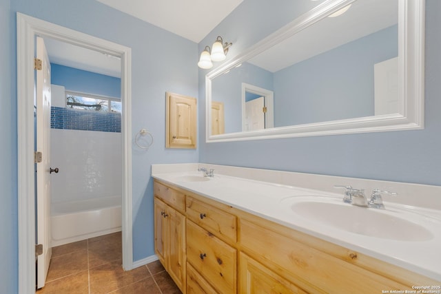 full bathroom with shower / bathtub combination, double vanity, tile patterned flooring, and a sink