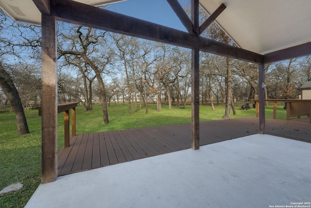 wooden deck with a patio and a yard