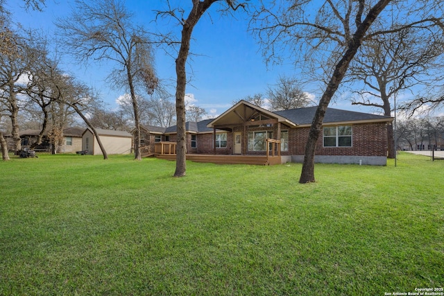 view of front of home with a front yard and brick siding