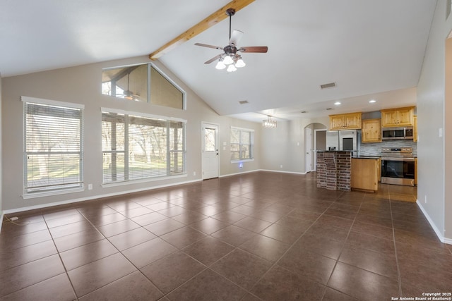 unfurnished living room featuring ceiling fan with notable chandelier, dark tile patterned floors, visible vents, baseboards, and beam ceiling