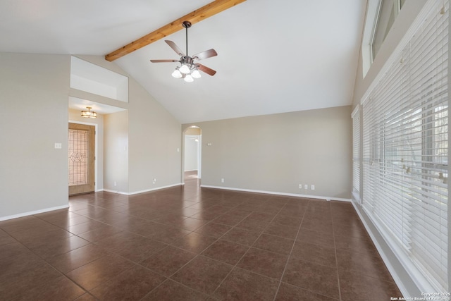 empty room with arched walkways, high vaulted ceiling, dark tile patterned floors, baseboards, and beamed ceiling