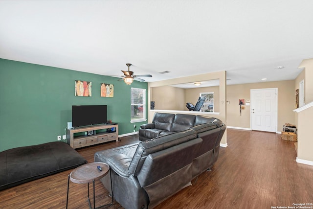 living room with dark wood-style floors, ceiling fan, and baseboards