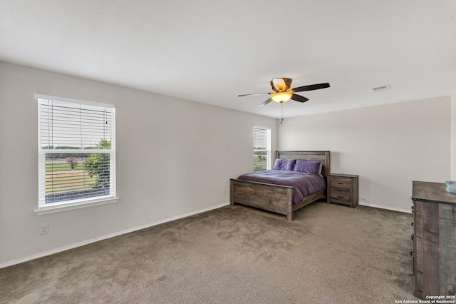 unfurnished bedroom with carpet floors, visible vents, and baseboards