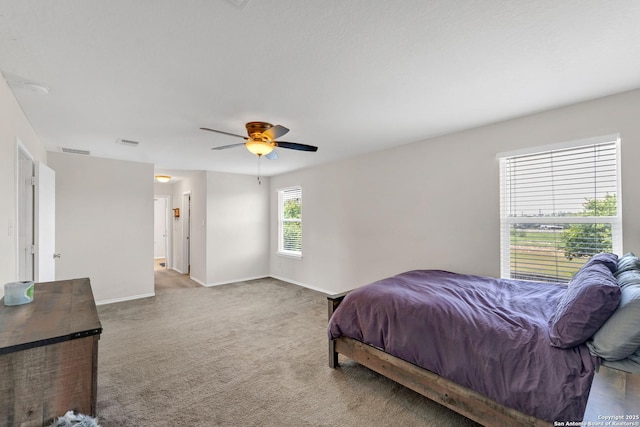 bedroom with carpet, visible vents, ceiling fan, and baseboards