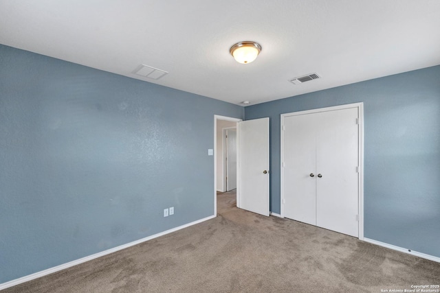 unfurnished bedroom featuring a closet, carpet, visible vents, and baseboards