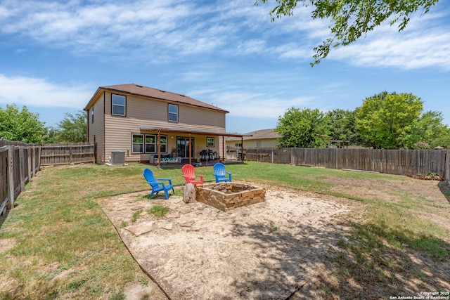 back of property featuring a fire pit, a lawn, a patio area, and a fenced backyard