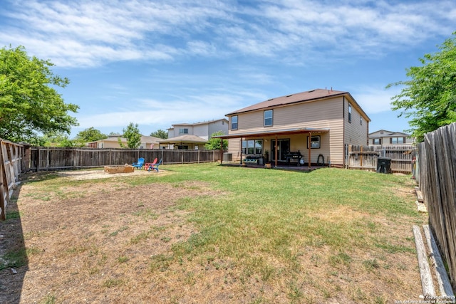 back of house featuring a yard, a patio area, and a fenced backyard