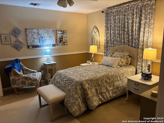 bedroom with ceiling fan, carpet flooring, and visible vents