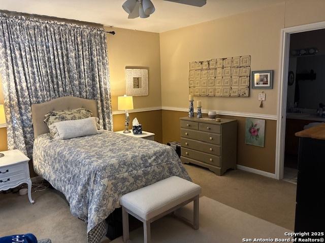 bedroom featuring light carpet and ceiling fan