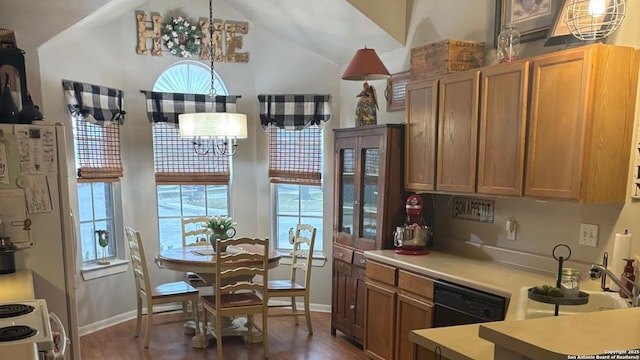 kitchen featuring brown cabinetry, dishwasher, light countertops, white electric range, and a notable chandelier