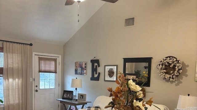 interior space featuring ceiling fan, high vaulted ceiling, and visible vents