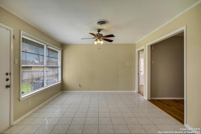 unfurnished room featuring light tile patterned floors, ceiling fan, visible vents, and baseboards