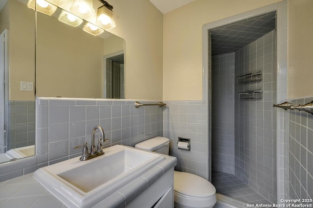 bathroom with wainscoting, tile walls, toilet, and vanity