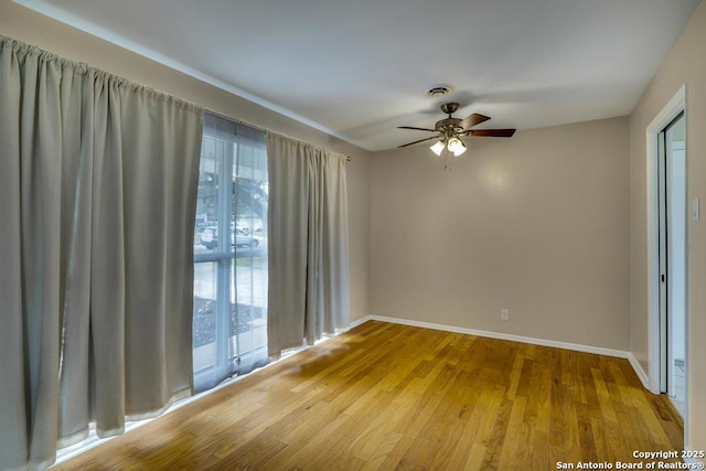 unfurnished room with a ceiling fan, baseboards, visible vents, and light wood finished floors