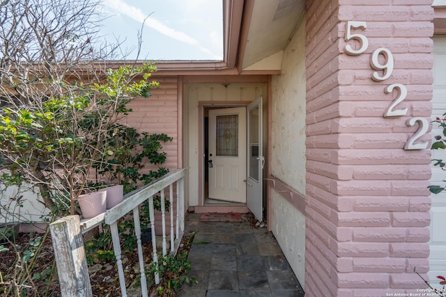 property entrance with brick siding