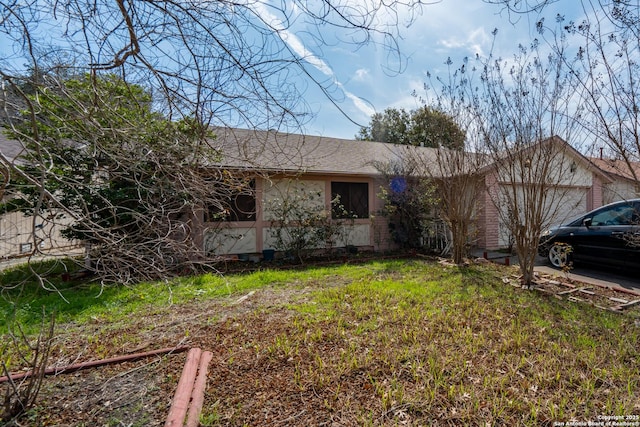 single story home featuring a garage and a front yard