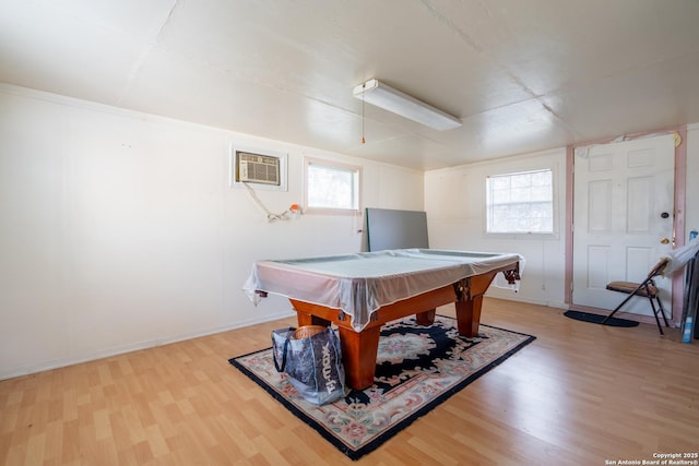 rec room featuring light wood-style floors, baseboards, an AC wall unit, and pool table