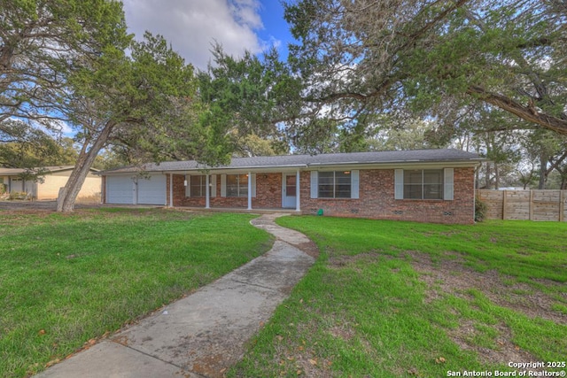 ranch-style home featuring crawl space, an attached garage, fence, a front lawn, and brick siding