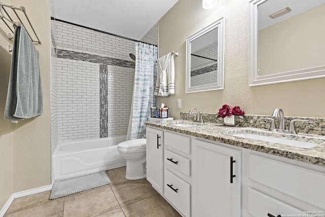 full bath with double vanity, tile patterned flooring, visible vents, and a sink