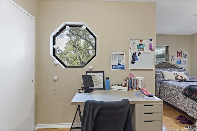 office area with light wood-style flooring and baseboards